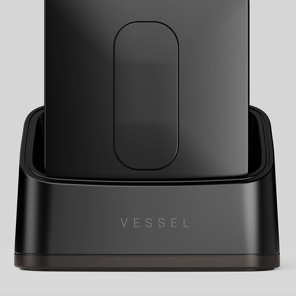 Vessel Compass Rise with front face button on Apex Base charging stand in matte black