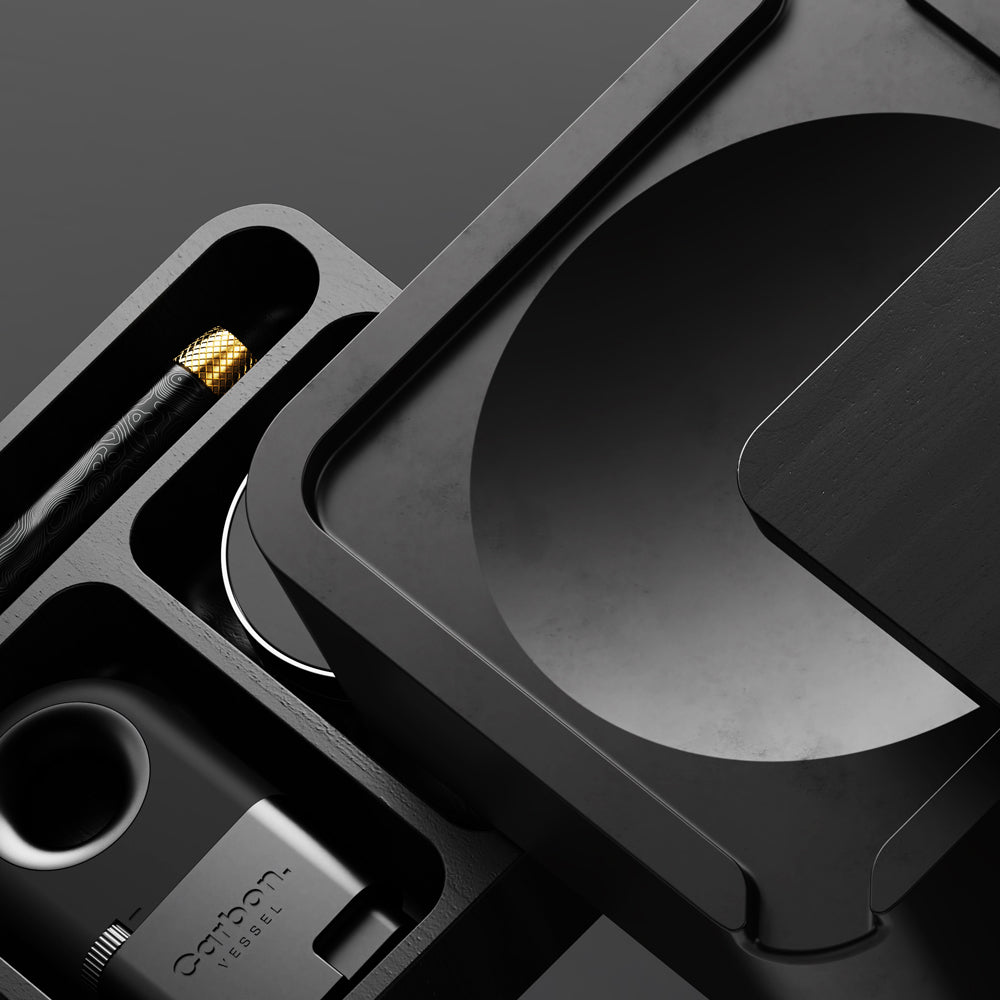 Vessel black wood ashtray set with storage organizer featuring matte black cover, cement bowl, Helix one hitter, carbon lighter, and Mill Blackwood grinder